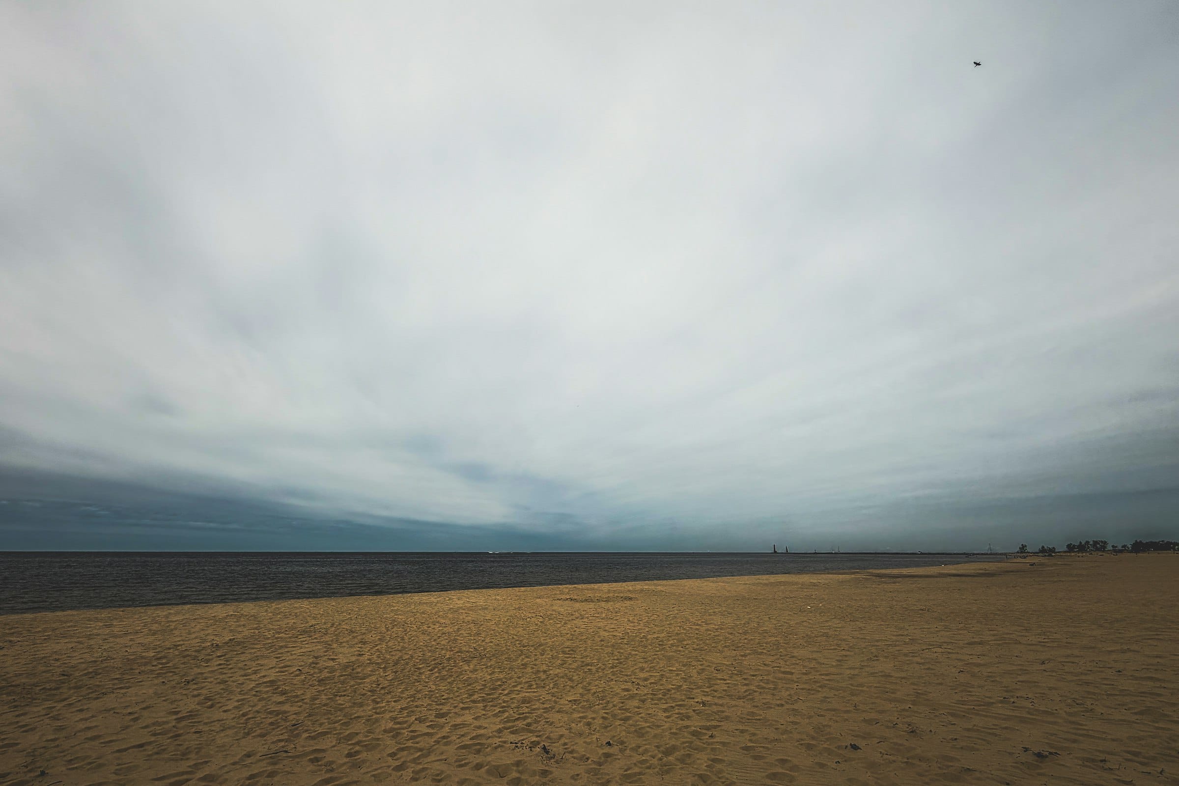 An empty beach in pale, cool winter light